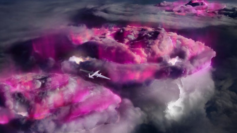 A plane flies over the tops of thunderclouds that are glowing purple.